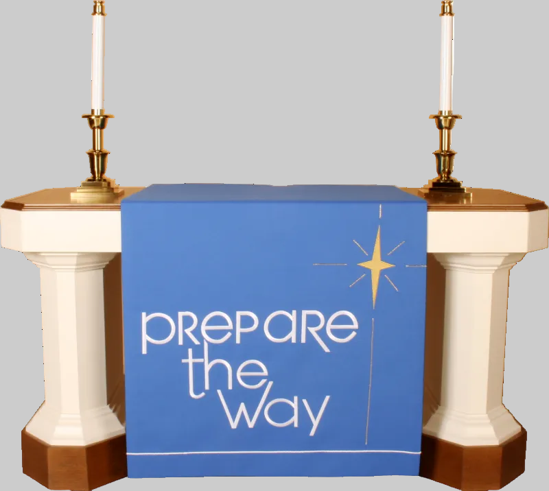 Decorative table with blue runner and 'Prepare the Way' text between two candlesticks on a white background
