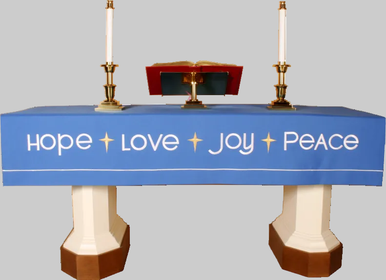 Table with a blue tablecloth displaying 'Hope Love Joy Peace' text, flanked by candles and a book.
