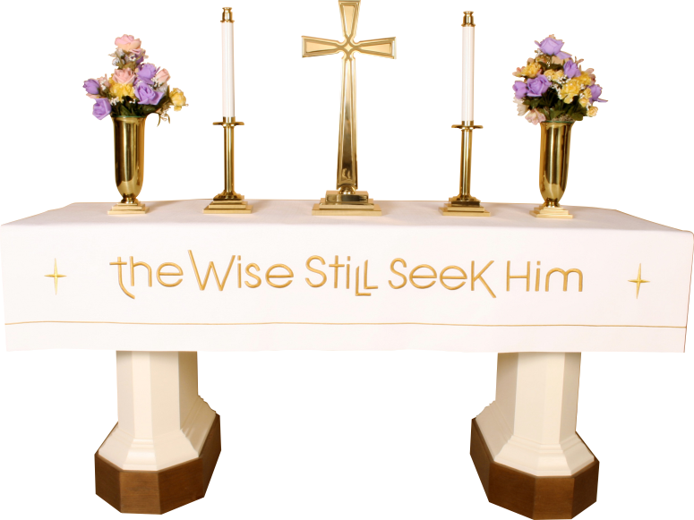 Decorative table with flowers, candles, and a cross with 'the Wise Still Seek Him' text.