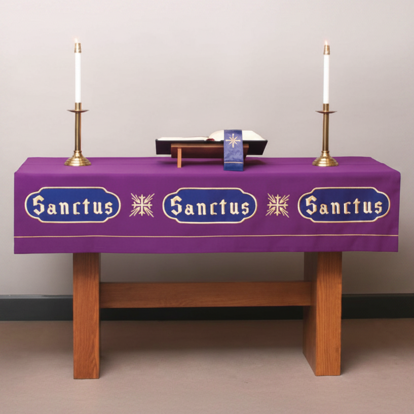 Purple tablecloth with ' Sanctus' text on a wooden table