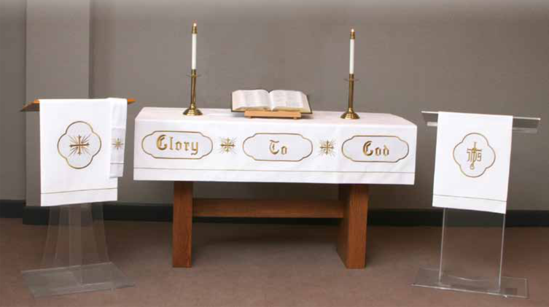 Altar with white cloth, candles, and a Bible in a church setting