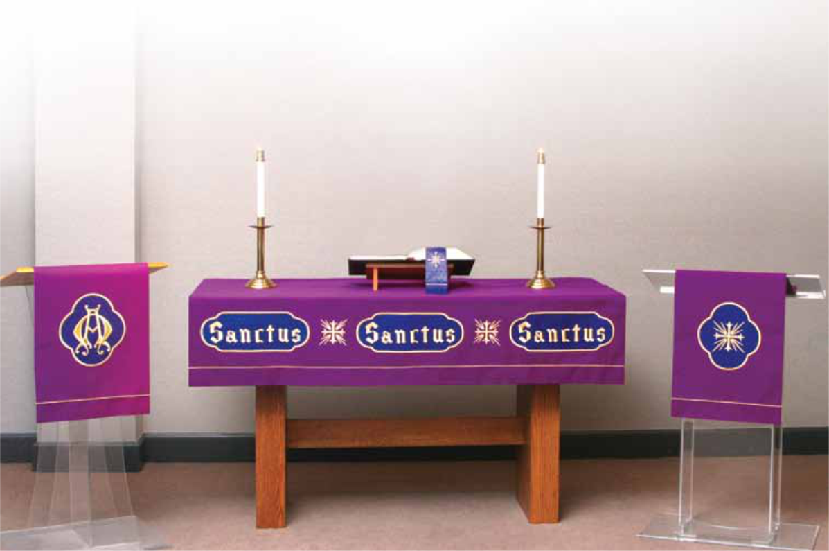 Purple altar table with 'Sanctus' text, candles, and banners in a church setting.
