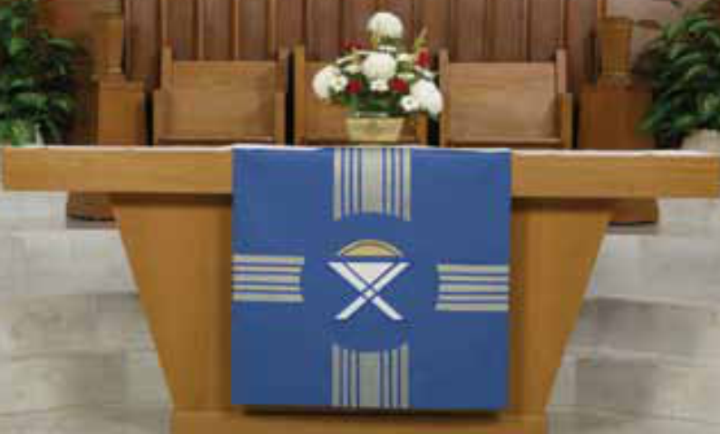 Pulpit with a blue and white decorative cloth in a church setting