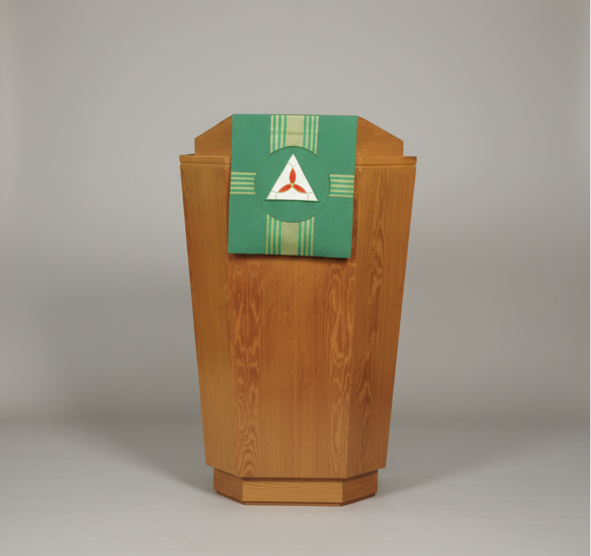Wooden lectern with a green and white decorative banner featuring a red triangle symbol.