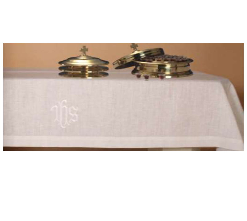 Two brass objects on a white cloth with 'IHS' branding against a beige background