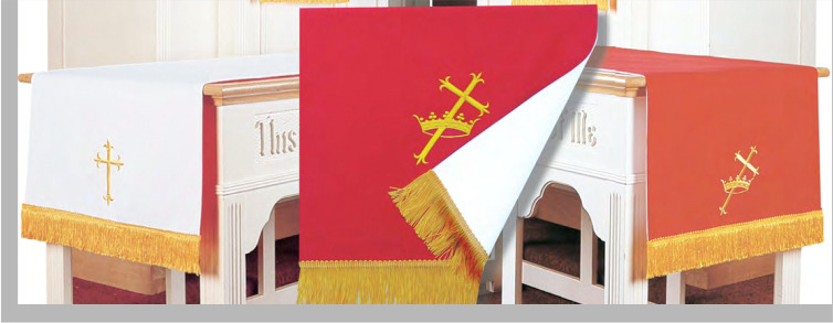 Red and white tablecloths with gold fringe and cross design on a church altar.